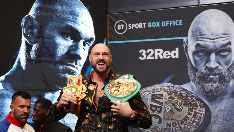 Tyson Fury shows off his WBC and Ring Magazine belts before his fight with Dillian Whyte