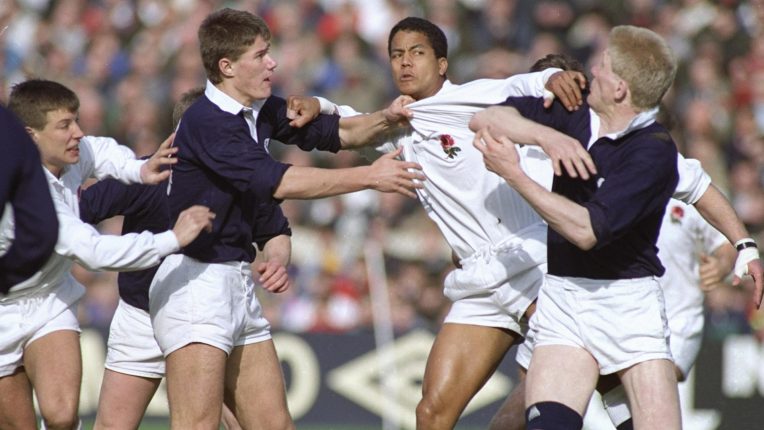 Guscott of England (centre-left) gets to grips with Stanger of Scotland