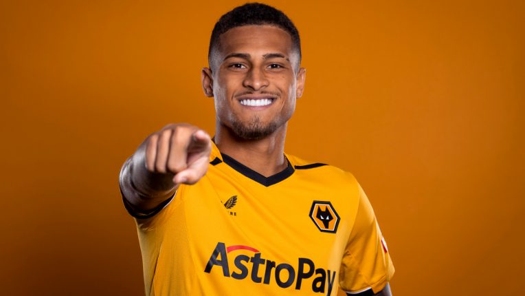 Joao Gomes points to the camera during his Wolves unveiling