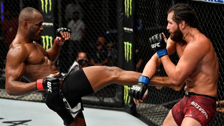 Kamaru Usman kicking Jorge Masvidal in the main event at UFC 251