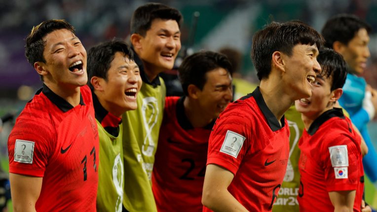Hwang Hee-chan (left) celebrates with team-mates after his winner puts South Korea through