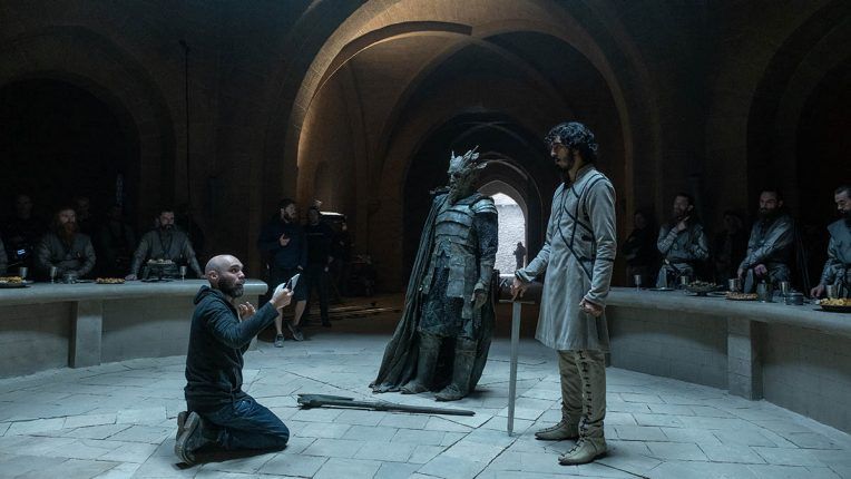 David Lowery, Ralph Ineson and Dev Patel on the set of The Green Knight