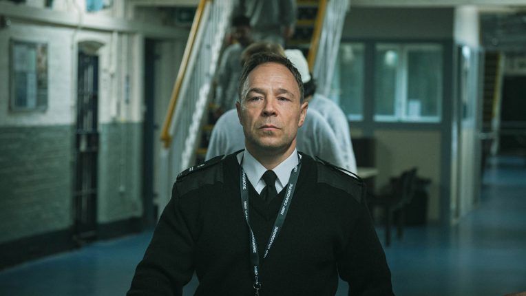 Stephen Graham's character Eric walking through the prison in Time