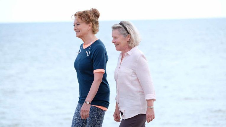 Imelda Staunton walking on the Sussex beach filming the ITV drama Flesh and Blood