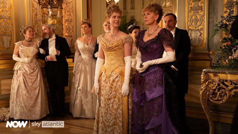 The Gilded Age cast in character in a ballroom