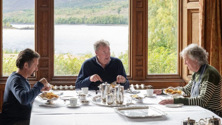 Richard Hammond, James May and Jeremy Clarkson eating a meal together in the Grand Tour Scotland special Lochdown